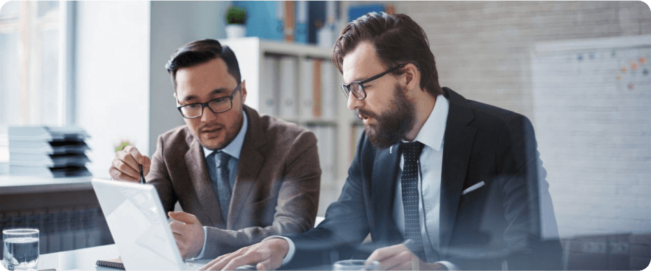 Business colleagues collaborating at a laptop